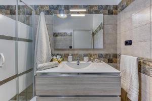 a bathroom with a sink and a mirror at Villa Elena in Marina di Pescoluse