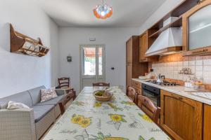 a kitchen with a table and a counter top at Villa Elena in Marina di Pescoluse +22 photos