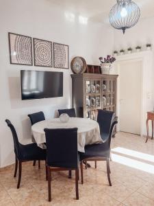 a dining room with a table and chairs at Boutique maison Filiatra in Filiatra