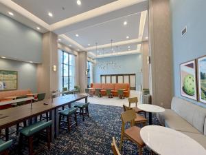 a waiting room at a hospital with tables and chairs at Hampton Inn and Suites Robbinsville in Robbinsville +36 photos
