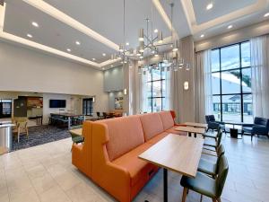 a living room with a couch and a table at Hampton Inn and Suites Robbinsville in Robbinsville