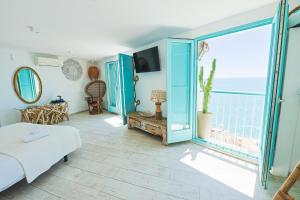 a living room with a bed and a large window at Respirar in Peniscola