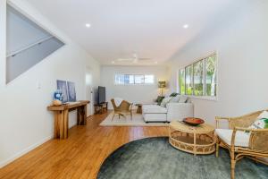 a living room with a couch and a table at 10 Beach Houses in Agnes Water