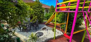 a playground with a colorful play structure in a garden at PENSIUNEA ETAP in Arad