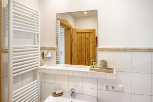 a bathroom with a sink and a mirror at Ferienhaus Haussee in Himmelpfort +34 photos