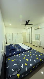 a bedroom with a bed and a ceiling fan at Hm home 2 in Sepang