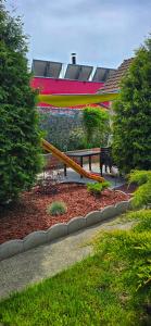 a picnic table with a surfboard on it in a park at PENSIUNEA ETAP in Arad +13 photos