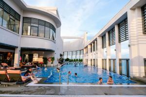 a group of people in a swimming pool in a building at Bow Luxury 3 in Danang