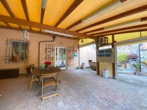 a patio with a wooden ceiling and a table at Locanda Cà de Rusitta in Vezzi Portio