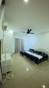 a bedroom with a bed and a ceiling fan at Hm home 2 in Sepang
