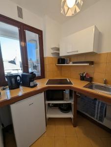 a kitchen with a sink and a counter top at Appartement de charme in Concarneau