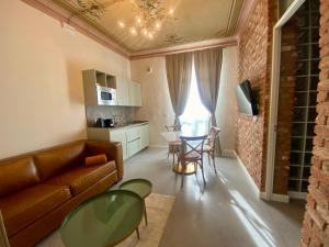 a living room with a couch and a table and chairs at Corte San Martino in La Morra