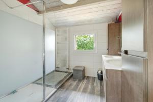 a small bathroom with a sink and a window at Vacances chez Cali - Maison 10 pers in La Séguinière +17 photos