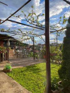 a pergola with a table and chairs in a yard at Apartments Stefan Trpejca in Ohrid +10 photos