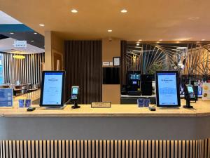 a counter with three cell phones on display at Eurotraveller Hotel - Premier - Tower Bridge in London