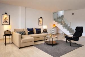 a living room with a couch and a staircase at Mountain Villa with Pool by NRAS in Orcheta