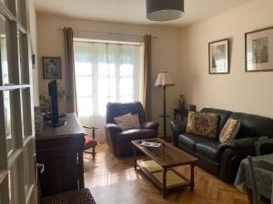 a living room with a couch and a chair at Treignac Tourelles in Treignac