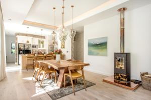 a dining room with a table and a fireplace at Wechmarshof in Stellenbosch