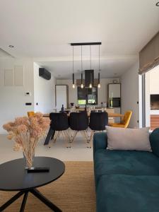 a living room with a blue couch and a table at Villa Karpa in Pridraga
