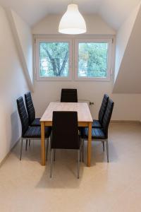a dining room with a wooden table and chairs at Lakeview Apartment in Ostriach +5 photos