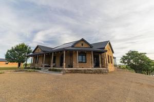 a house with a black roof on top of it at Waterval Guest Farm in Bloemfontein