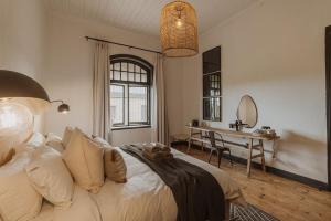 a bedroom with a bed with a teddy bear on it at Waterval Guest Farm in Bloemfontein