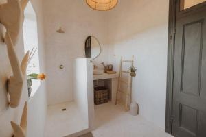 a white bathroom with a sink and a mirror at Waterval Guest Farm in Bloemfontein +38 photos