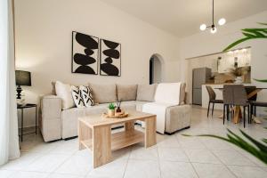 a living room with a couch and a table at Villa Margarita in Nótos