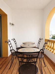 a dining room with a table and chairs at Sud Hôtel Restaurant in Bastia