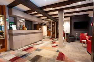a lobby of a store with a counter and chairs at Hotel Restaurant Père Benoît in Entzheim +52 photos
