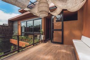 a balcony with a view of a house at Sana Vie Villa Seminyak by Ini Vie Hospitality in Seminyak