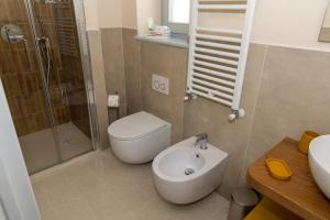 a bathroom with a toilet and a shower and a sink at Arco delle Apuane by Migliorini in Stazzema +56 photos