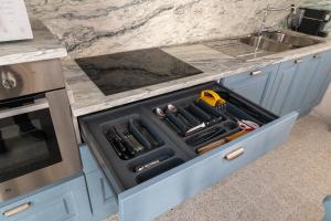 a drawer in a kitchen filled with cooking utensils at Arco delle Apuane by Migliorini in Stazzema