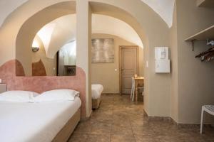 a bedroom with a bed in a room with arch ceilings at Sud Hôtel Restaurant in Bastia +143 photos