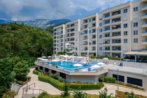 an external view of a hotel with a swimming pool at Status-M Apartments 176 in Bečići