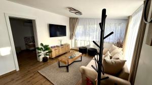 a living room with a couch and a table at TJ Nyaraló in Markaz
