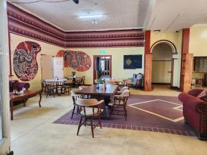 a restaurant with tables and chairs in a room at Hotel Cecil Wondai in Wondai