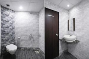 a bathroom with a toilet and a sink at FabHotel Marvey Residency in Mumbai +25 photos