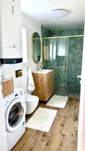 a bathroom with a washing machine and a toilet at TJ Nyaraló in Markaz +27 photos