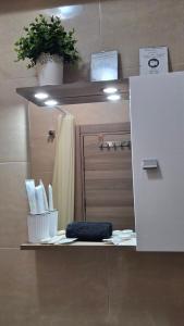 a bathroom with a door and a sink with a towel at Apartament COSTA in Mamaia +8 photos