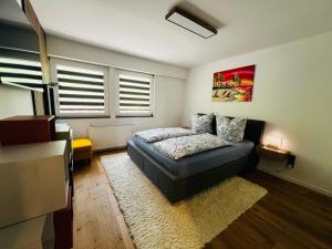 a bedroom with a bed and a couch in it at Traum Berg - Koppelberg 2 in Traben-Trarbach