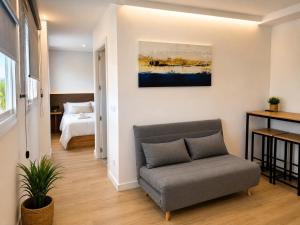 a living room with a couch and a bed at Nova MSuites Valencia in Valencia