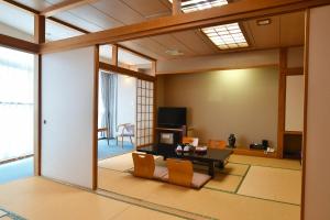 a living room with a couch and a table at Zekkeino Yado Inubohsaki Hotel in Choshi