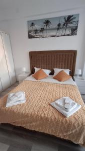 a bedroom with a bed with two towels on it at Apartament COSTA in Mamaia