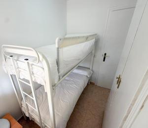 a white bunk bed in a small room at Respiro di Levante in Oropesa del Mar