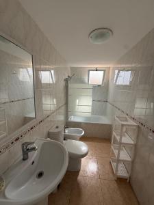 a bathroom with a sink and a toilet and a tub at Respiro di Levante in Oropesa del Mar