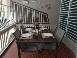 a dining room table with chairs and wine glasses at Charming 3-Bedroom House Steps from Luquillo Beach in Luquillo