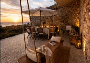 a patio with a table and an umbrella at Casa dos Rebolinhos in Sagres
