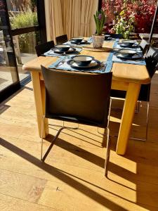a wooden table with chairs and a table cloth on it at Alpine Abode in Wanaka