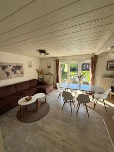 a living room with a table and a couch at Nordwind Sjut in Warnow